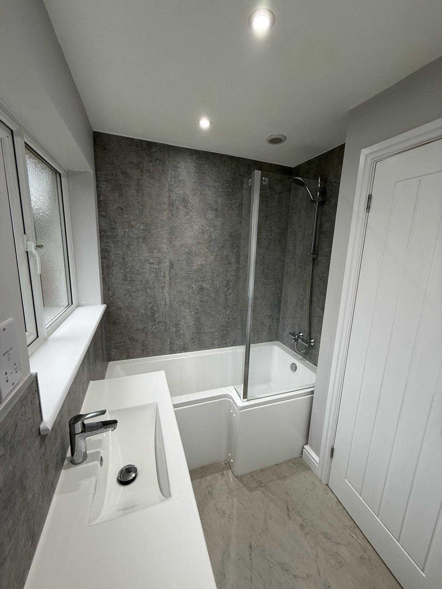 Refitted bathroom with new downlights and extractor after a full rewire