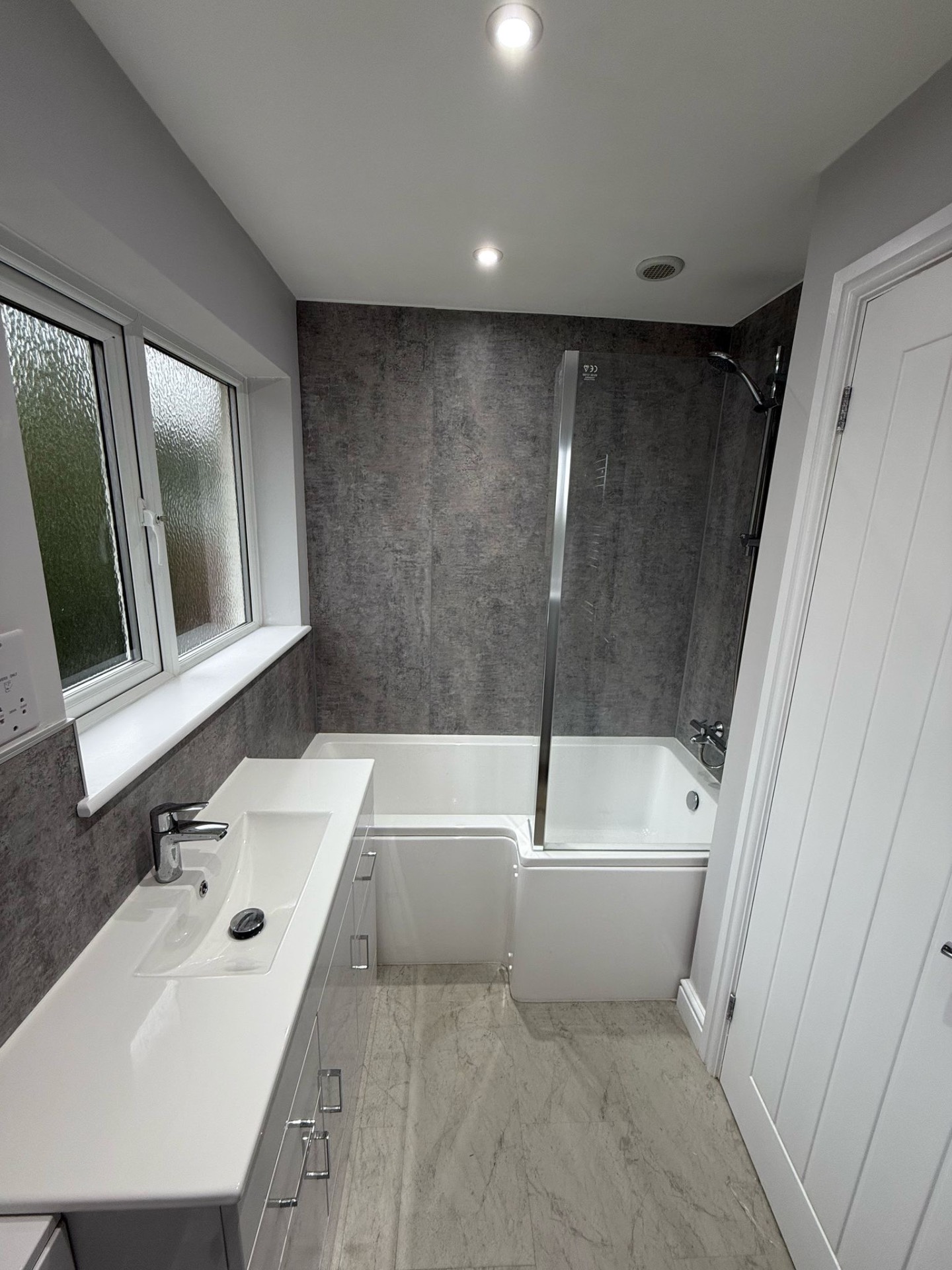 Bathroom with new IP-rated downlights and extractor after a full rewire