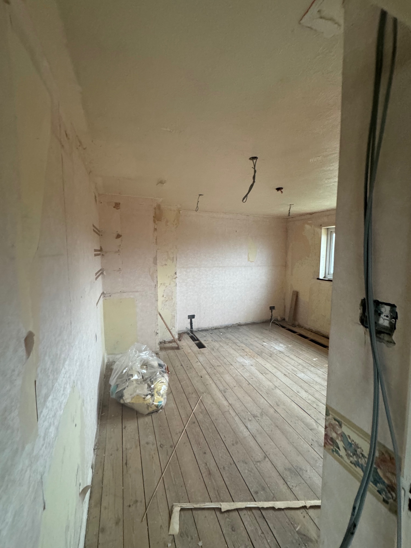 Bedroom before the rewire — old cabling and fittings removed